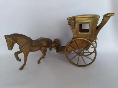 A nice, vintage heavy solid brass horse carriage. wheels turn It is in perfect condition, and can be...