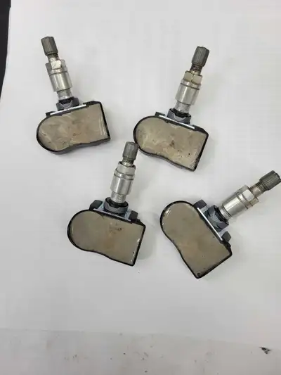 Selling a set of four Nissan tire pressure sensors, each operating at 433 MHz. One sensor is brand n...