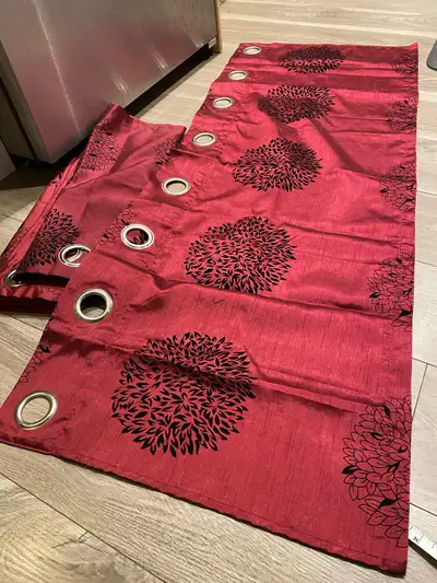 Beautiful deep red curtains with black floral patterns — perfect for adding warmth and style to any...