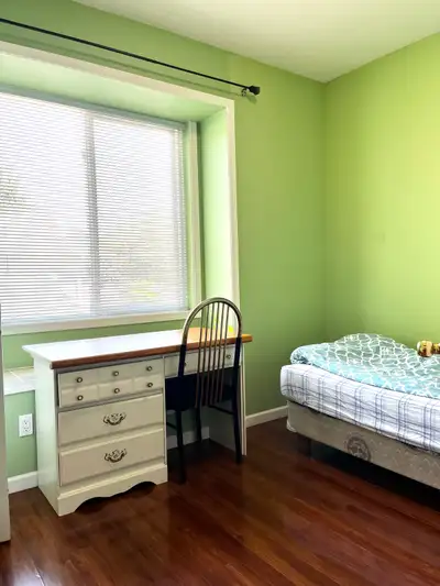 Furnished bedroom has a bed, desk, chair, closet, bookcase and a window. *Shared kitchen, living roo...