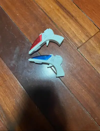 Two small plastic toy guns. One red light, one blue light. Makes noises. $5 each. $8 for both.