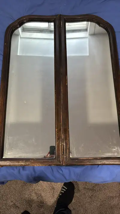Vintage bi-fold mirror. 32 tall x 24 wide. Has a dark wood frame with an arched top design. Great fo...