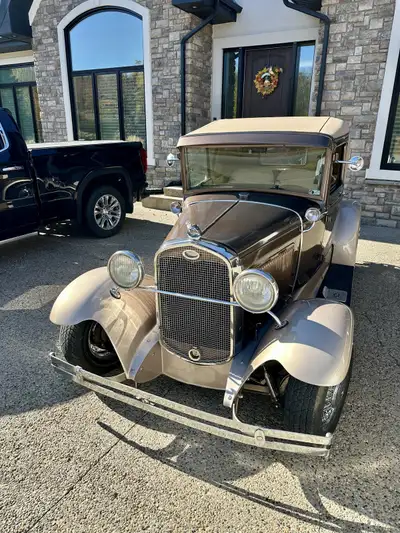 1930 Ford Model A Coupe a true classic with a charming two-tone brown and beige metallic exterior. T...
