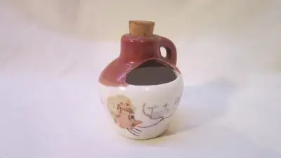 This cute jug is in good used condition. It measures 2&1/4 inches tall, and 6 inches around the body...