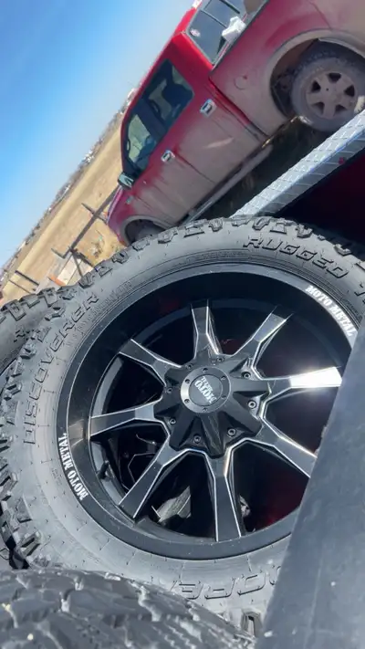 Selling both my rims stock an aftermarket Moto metal black 20x10 Plain black dodge ram rims 1350obo...