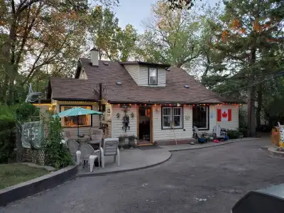 This charming and well-loved residential home features a cozy interior with a spacious living room a...