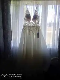 Dress is brand new, it was never worn still has tag and is in original bag!! Size 18 Ivory in color...