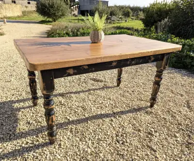 Free Table to a good home. Golden wood top with a flat black bottom and nice turned legs. Size: 30"W...