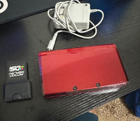 Red Nintendo 3DS with charger and action replay and stylus