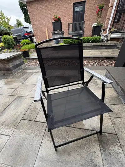These four brand new folding patio chairs feature a sleek black metal frame and durable breathable m...