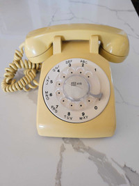 Vintage yellow rotary dial phone