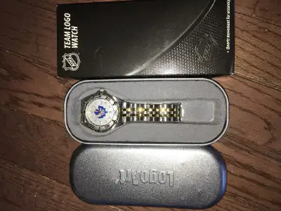 This luxurious wristwatch features a brushed chrome finish, brass case with gold tone accents on a r...