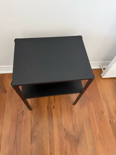 Simple, sturdy and stylish! This IKEA black side table with a lower shelf is the perfect minimalist...