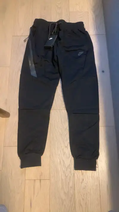 All black Nike Tech pants, View more