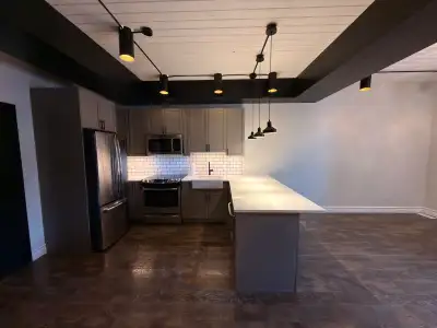 Welcome to the the Roland Church Lofts! Located in Roland, this suite features original 1914 brick w...