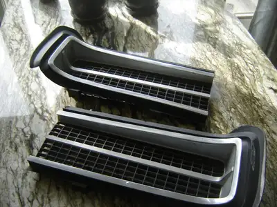 Original GTO grille includes the chrome moldings. One side has a small crack (finger points to it in...