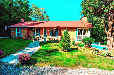 Live Among Nature's Beauty in this Detached Brick & Log Home.