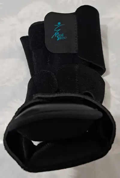 This is a black Med Spec ankle brace, size small, designed to provide support and stability. It's in...
