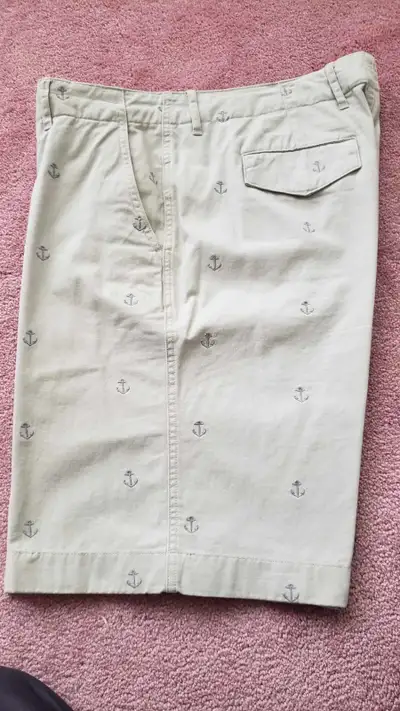 2 pair of men's shorts, size 36. Taupe colored shorts with anchors are made by Tommy Hilfiger, and t...