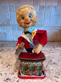 Early antique tin toy, 1960, bartender nose goes bright. Working