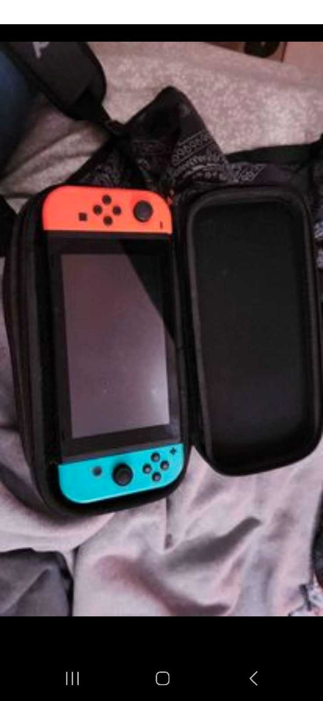 Nintendo Switch with 2 sets of joycons and case in Nintendo Switch in Kawartha Lakes - Image 3