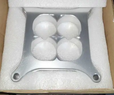 This aluminum intake carburetor manifold is designed with four holes and is in new condition, still...