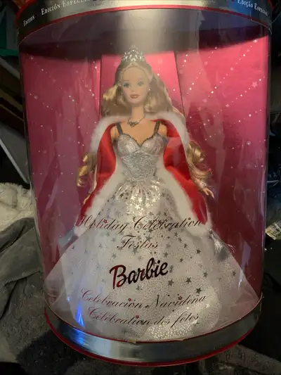 Add a touch of festive elegance to your collection with this 2001 Holiday Celebration Barbie, a Spec...