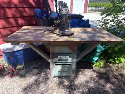 Vintage Dewalt Radial Arm Saw. Solid cast unit, on custom table with drawers. Comes with additional...