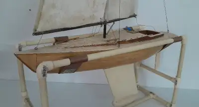 Model sailboat from Dumas I believe. Comes with stand, radio and servos. Needs a good detail, been i...