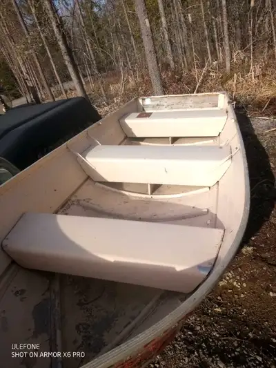 Good old 14ft aluminum boat. Bottom patched. Non running ( not sure of year,1972?) Johnson 9.5hp out...