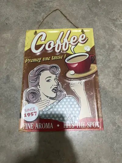 Set of two vintage-inspired tin signs. Coffee sign measures 11” x 16”. Truck sign measures 19” x 13”...