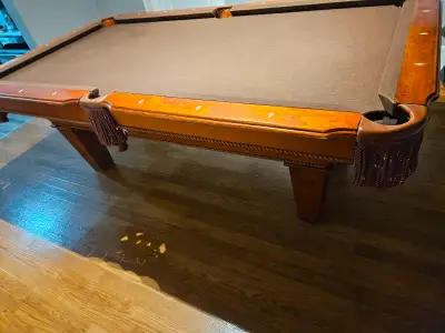 Hardwood pool table comes with pro pool sticks and 2 set of balls asking $ 750