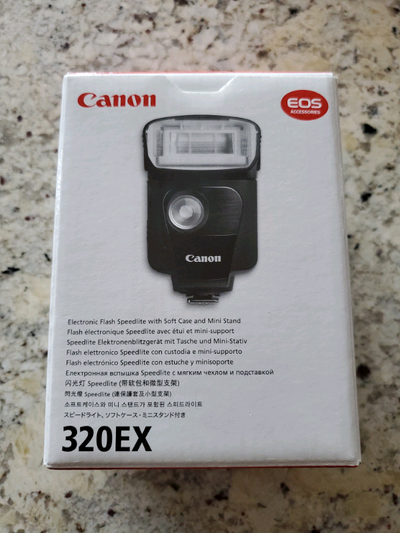 Selling a brand new Canon 320EX Speedlite. This electronic flash includes a soft case and mini stand...