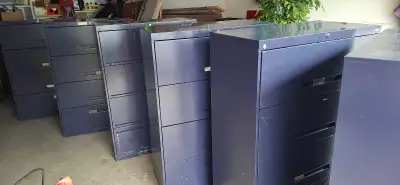 Durable metal lateral filing cabinet in a dark blueish grey finish. 4 wide drawers with integrated p...
