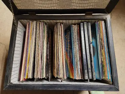 Leather Ottoman full of Vinyl Records 33 RPM. Over 70 vinyl records of various music; some box sets....