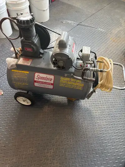 This is a used Speedaire air compressor with a portable tank, perfect for various tasks around the g...