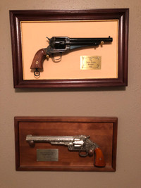 Jesse James and Wyatt Earp replica revolvers by Franklin mint.