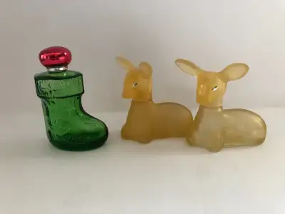 Three vintage Avon cologne glass Christmas themed bottles. "Christmas Surprise" and the amber twin p...
