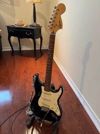 Black/white guitar Squire by Fender Affinity Series Comes with stand $300