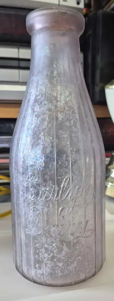 This is a vintage Carlyle Dairy milk bottle, a collectible piece of history, perfect for enthusiasts...