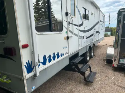 It has two Slide outs, King size bed, Two recliner chairs, TV VCR unit, barbeque that attaches to th...