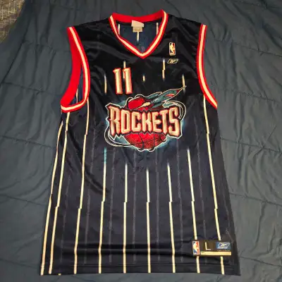 Own a piece of basketball history with this vintage Reebok NBA jersey featuring Yao Ming of the Hous...