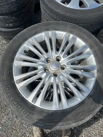 OEM Chrysler rims size 235/55/19 on Bridgestone tires. I’n good condition, rims have some scuffs, ti...
