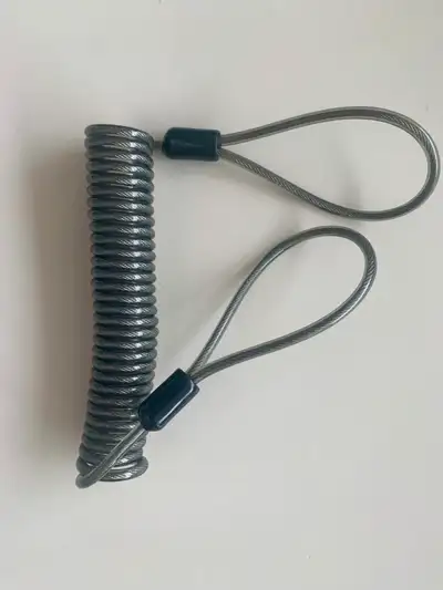 Compact retractable steel wire security cable suitable for securing small items at home, work, or wh...