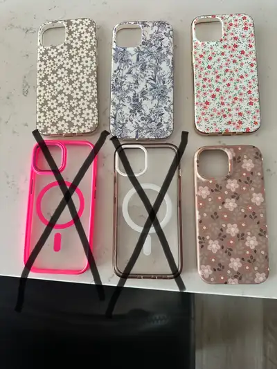Cute iPhone 13 cases. Has 5 different designs. Three cases with floral patterns, one hot pink clear...