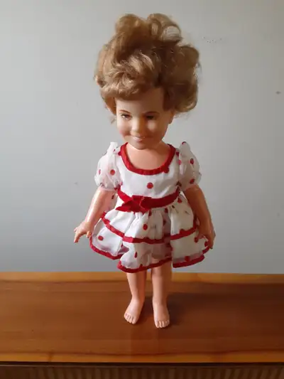 Here is a 16" Shirley Temple doll by IDEAL dolls. She is wearing her original ruffle polka dot dress...