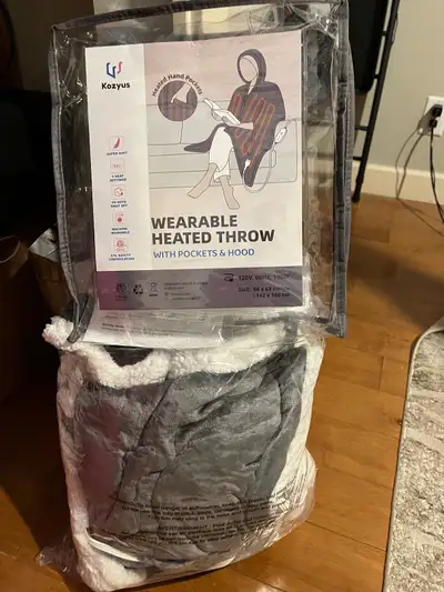 Wearable heated throw with pockets and hood; used once; almost new; $30; pick up at 20738, 84th Aven...