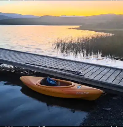 Get ready to paddle into adventure with this sporty orange Pursuit 80x kayak, measuring 8 feet long...