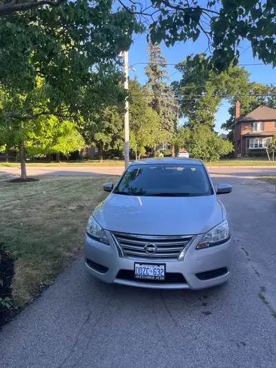 2015 Silver Nissan Sentra with 158k km on it. Works great with minimal upkeep. Slight dent in roof b...