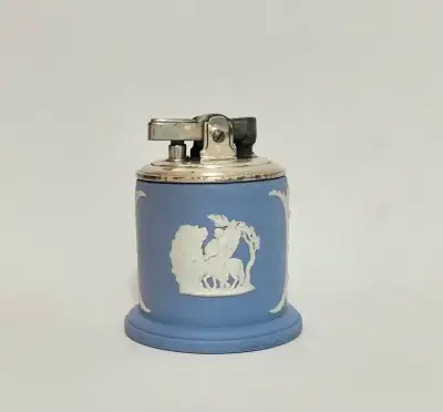 This is a highly collectible 1954 Wedgwood Blue Jasperware Ronson Table Lighter. It is marked with a...